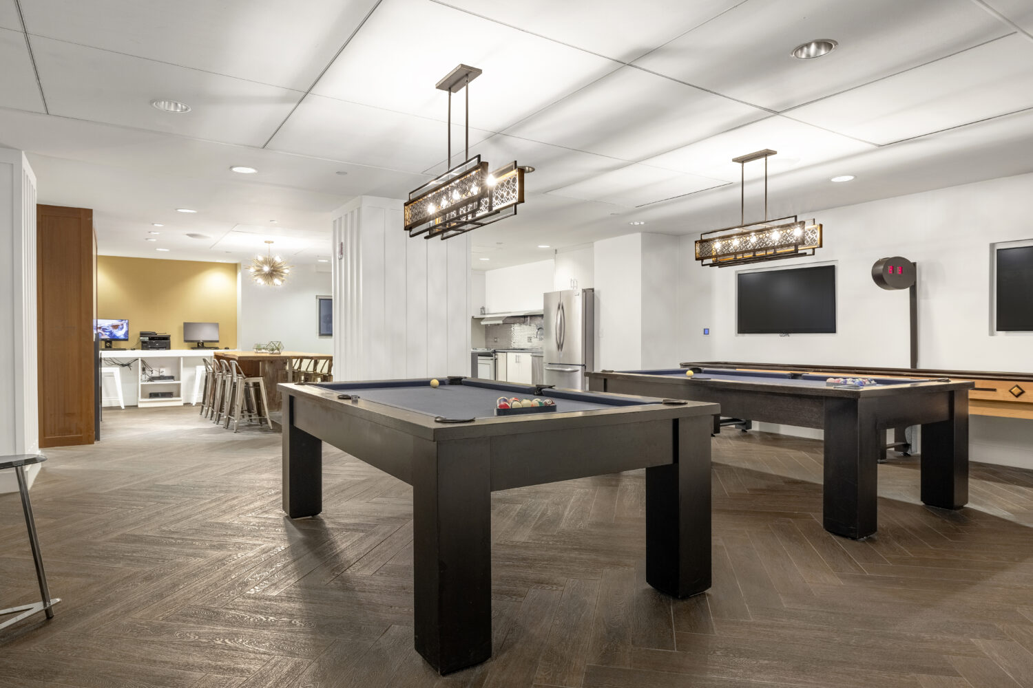 two pool tables and shuffleboard in club level lounge
