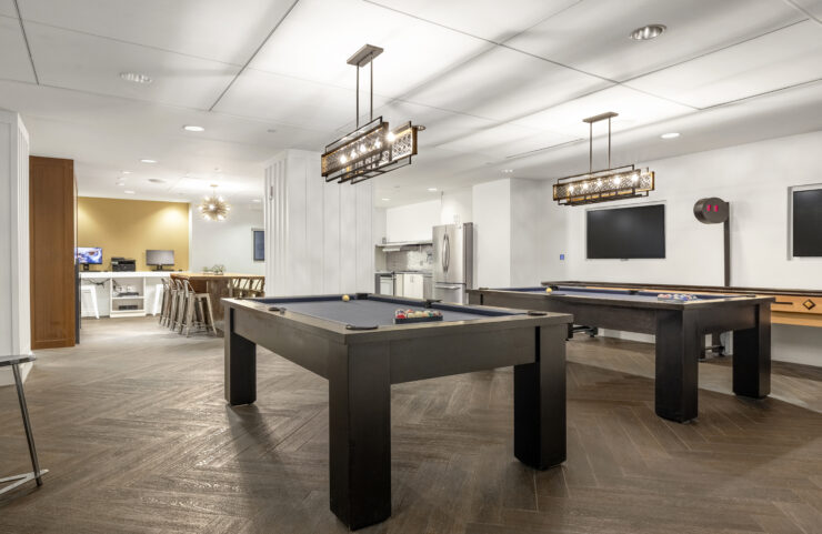 two pool tables and shuffleboard in club level lounge