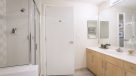 bathroom with double vanity and shower 