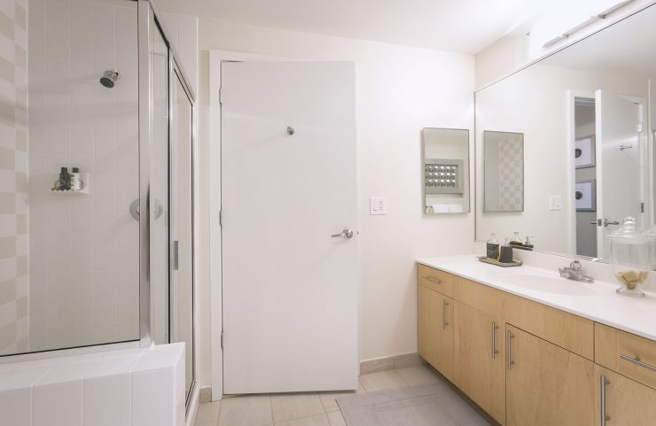 bathroom with double vanity and shower 