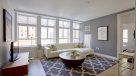 large living room featuring large windows to see the views of Philadelphia
