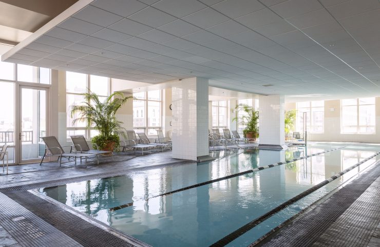 indoor pool surrounded by large windows 