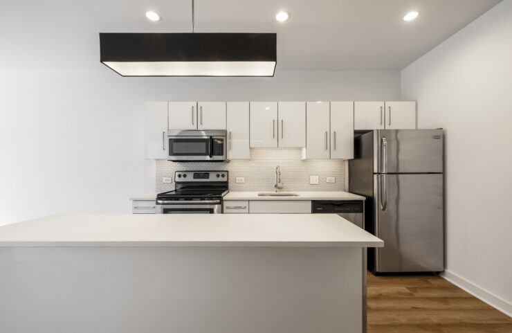 modern kitchen with white cabinets and stainless steel appliances