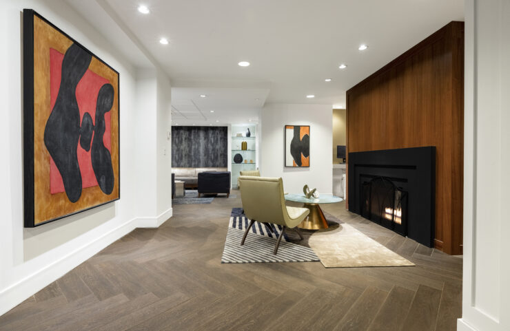 club level lounge with two chairs and a table by the fireplace