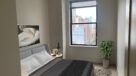 bedroom with a large window and great view