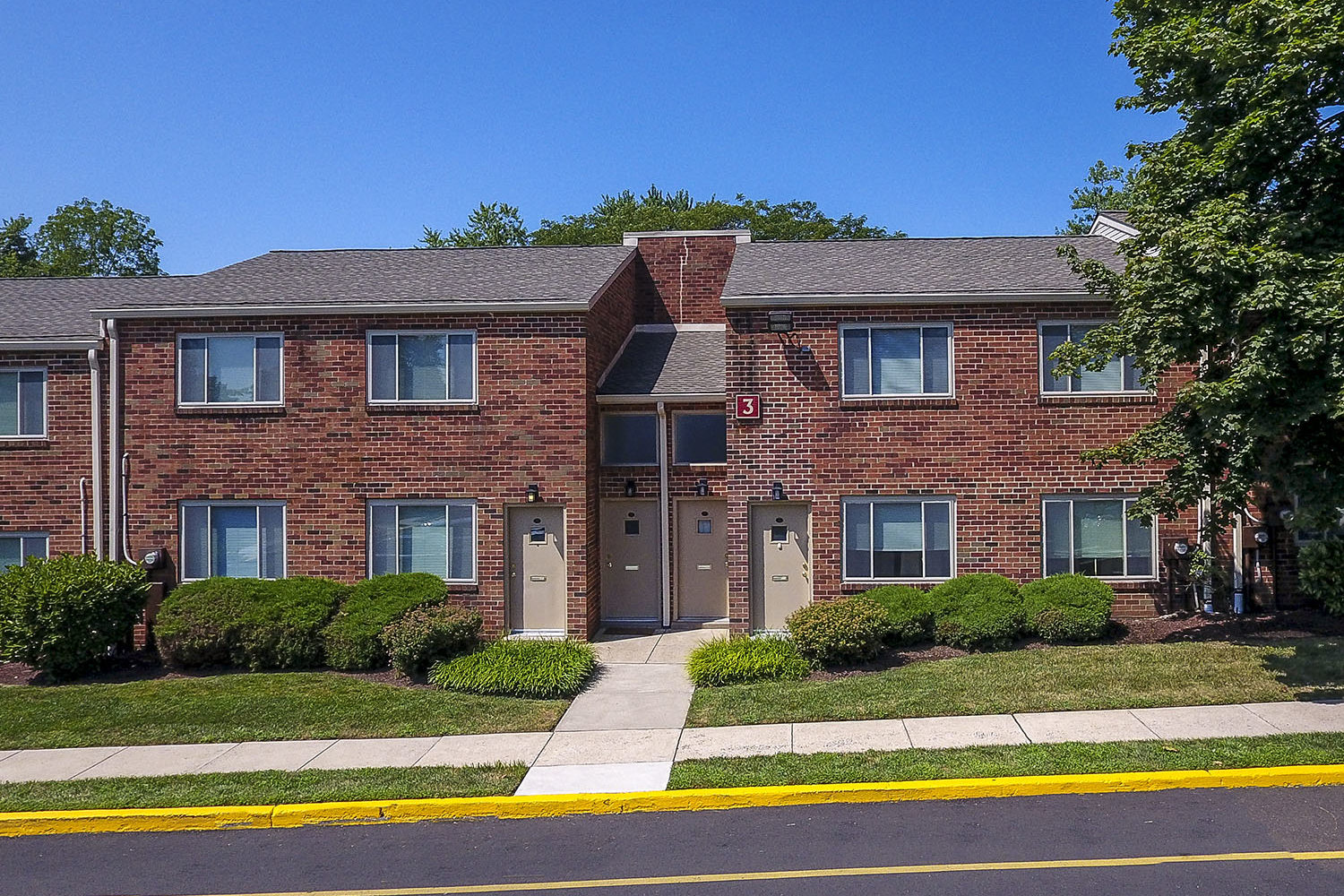brick exterior with landscaped walkways 