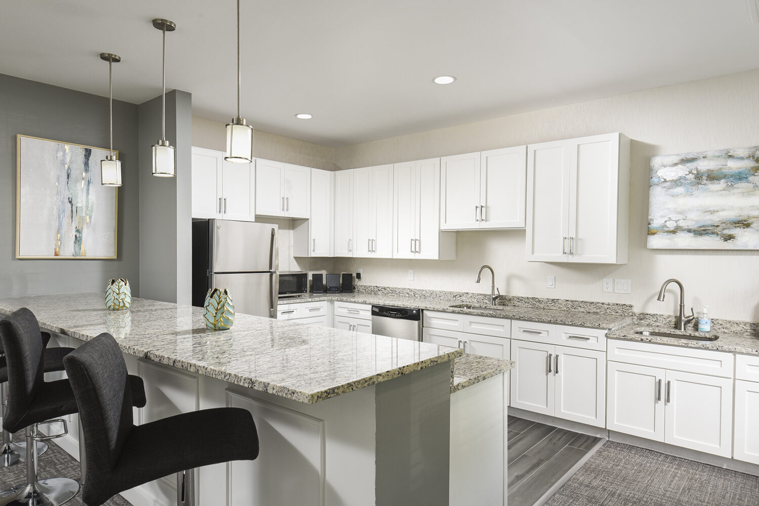 community room kitchen with an island with bar stools 