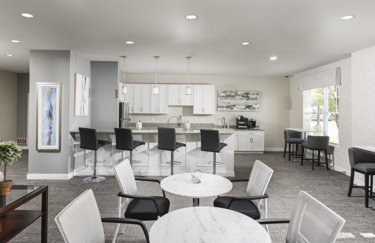 community room kitchen with an island with bar stools 