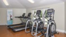 fitness center with treadmills and elliptical machines