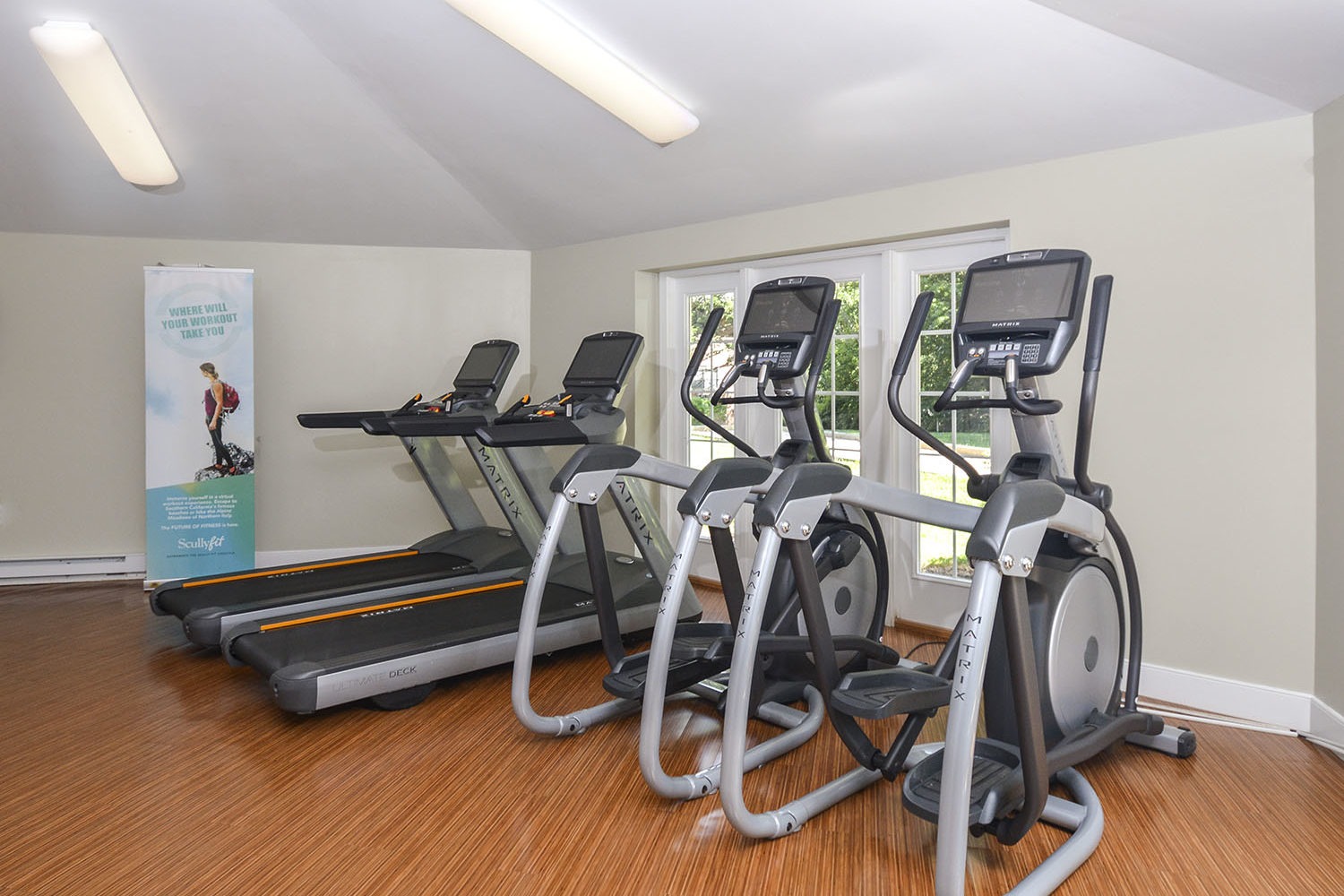 fitness center with treadmills and elliptical machines