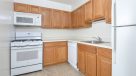 standard kitche with oak cabinets and white appliances