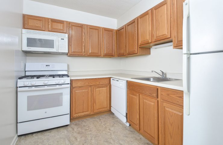 standard kitche with oak cabinets and white appliances