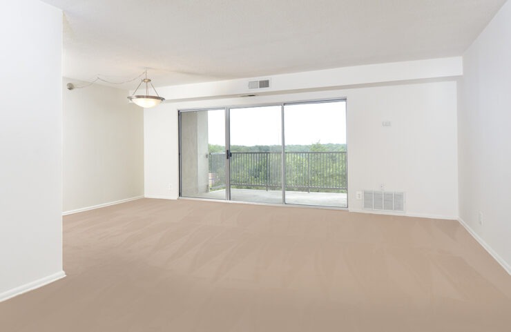 large carpeted living and dining area with access to balcony 