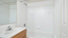 bathroom with tiled tub 