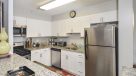 updated kitche with white cabinets and breakfast bar