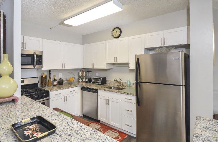 updated kitche with white cabinets and breakfast bar