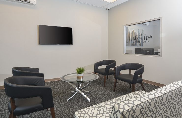 leasing office with sofa, chairs and flat screen TV
