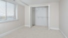 Penthouse bedroom with wall to wall carpeting and large closets
