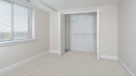 Penthouse bedroom with wall to wall carpeting and large closets