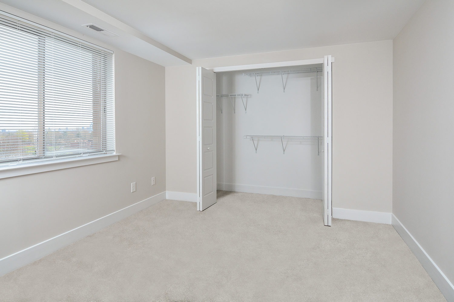 Penthouse bedroom with wall to wall carpeting and large closets