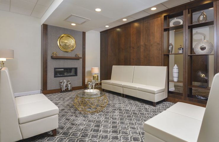 lobby with white seating area and fireplace