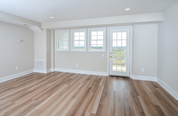 Penthouse living room with wood floors and access to balcony