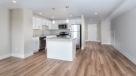 Penthouse open concept kitchen and living room with wood floors