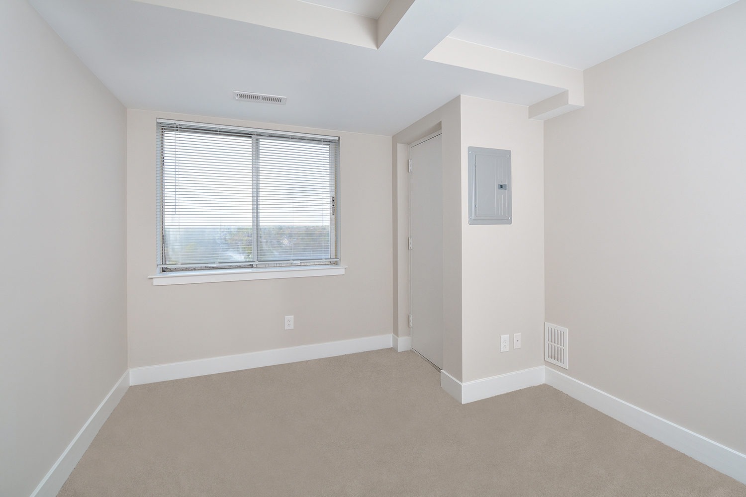 Penthouse bedroom with wall to wall carpets and large window to enjoy the view