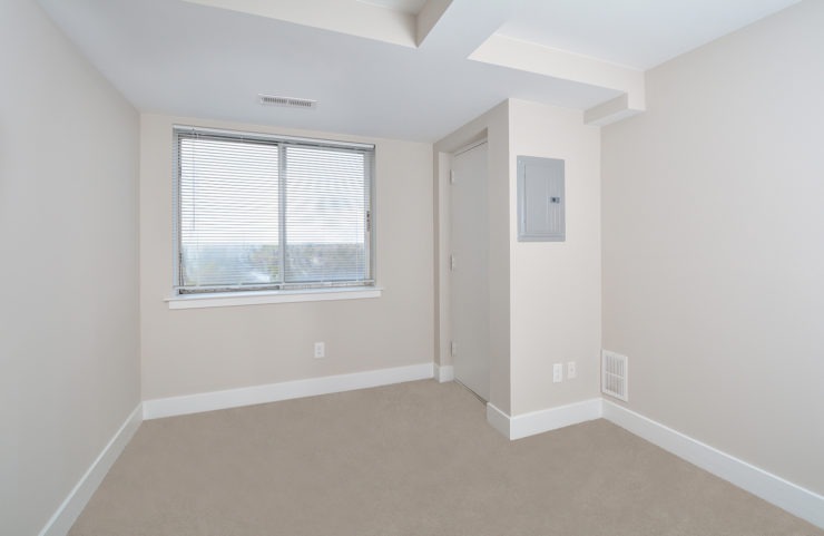 Penthouse bedroom with wall to wall carpets and large window to enjoy the view