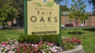 Fair Oaks sign with apartment building behind 