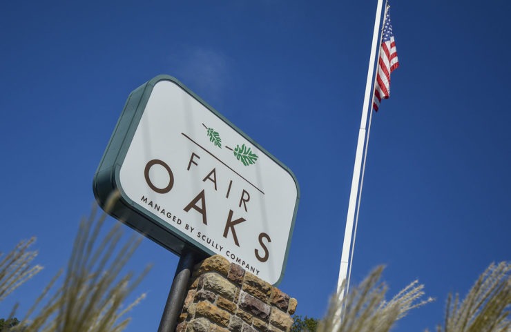 tall fair oaks sign with flag pole behind