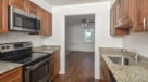 Galley Style Kitchen with hardwood floors looking out into dining room