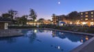outdoor pool looking at buildings lit up at night