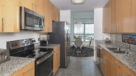 galley style kitchen with granite countertops and light wood cabinets