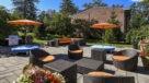 umbrella tables surrounded by beautiful potted flowers 