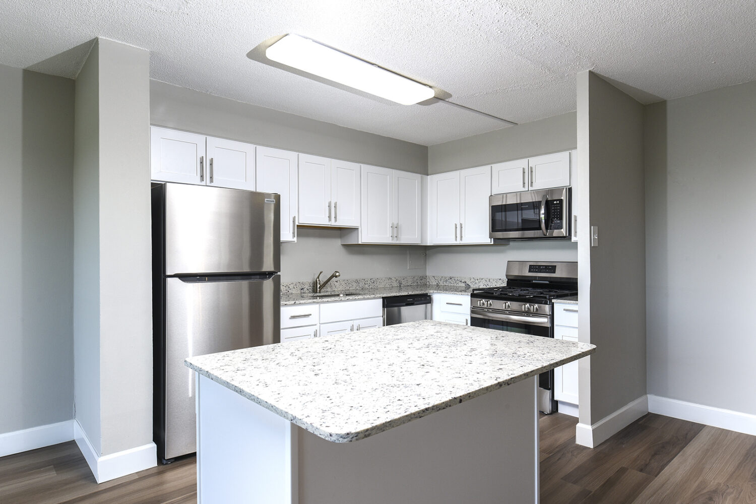 updated kitchen with white cabinets and breakfast bar