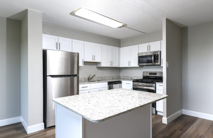 updated kitchen with white cabinets and breakfast bar