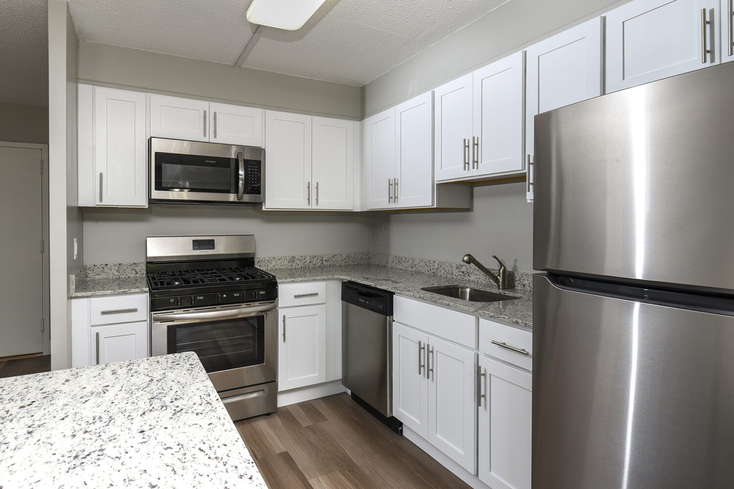 updated kitchen with white cabinets and breakfast bar