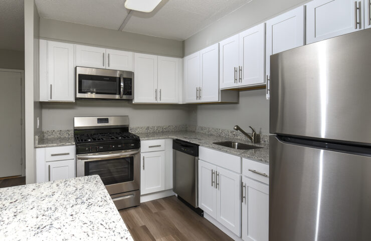 updated kitchen with white cabinets and breakfast bar