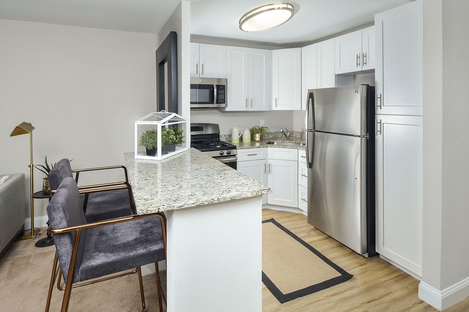 open modern kitchen with breakfast bar and two stools 