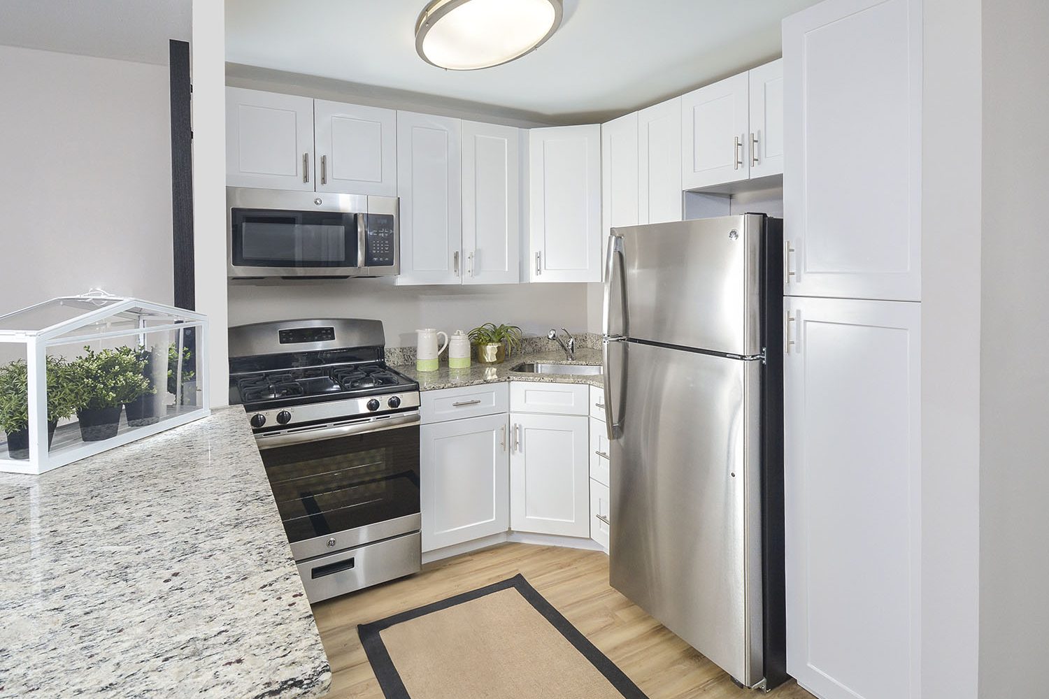modern kitchen with white cabinets and stainless steel appliances 