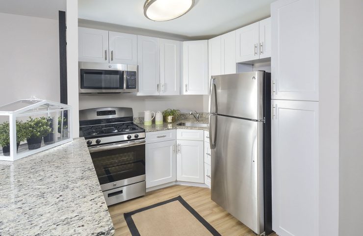 modern kitchen with white cabinets and stainless steel appliances 
