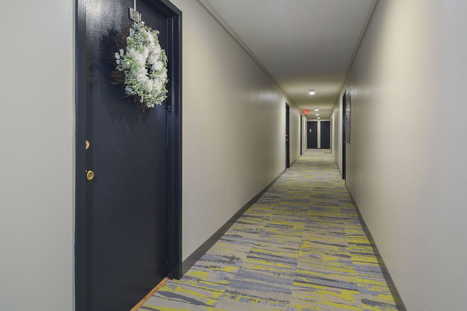 large bright hallway with entrances to apartments 
