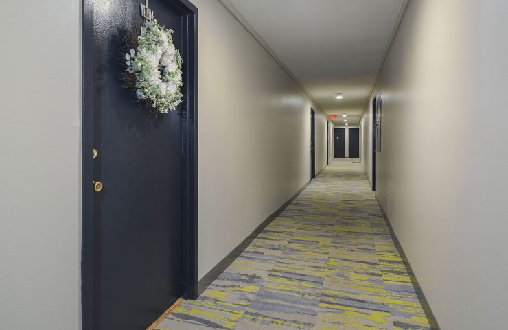 large bright hallway with entrances to apartments 