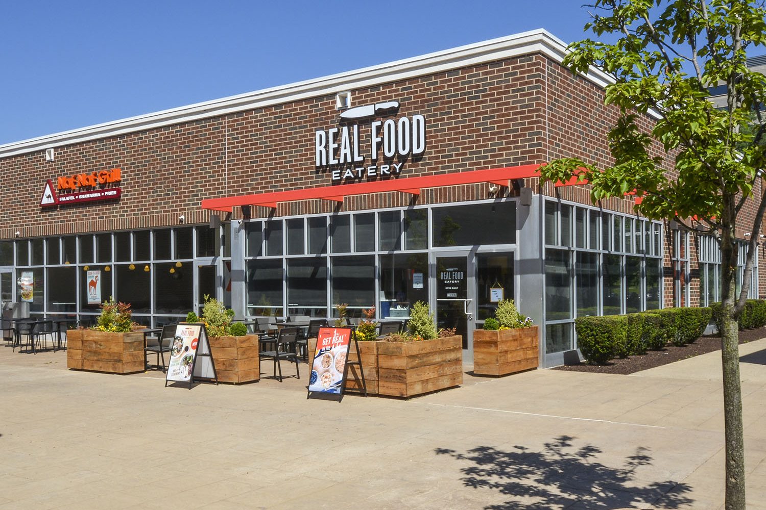 exterior photo of real food eatery with outdoor seating 