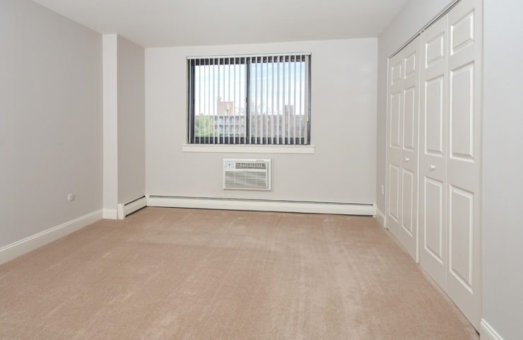 large bedroom with wall to wall carpet 