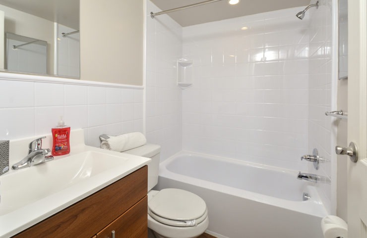 bathroom with white tile and cultured marble sink