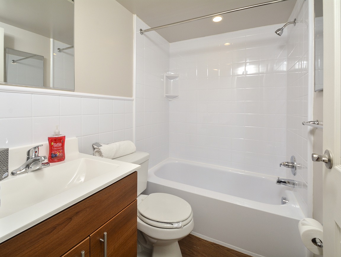 bathroom with white tile and cultured marble sink