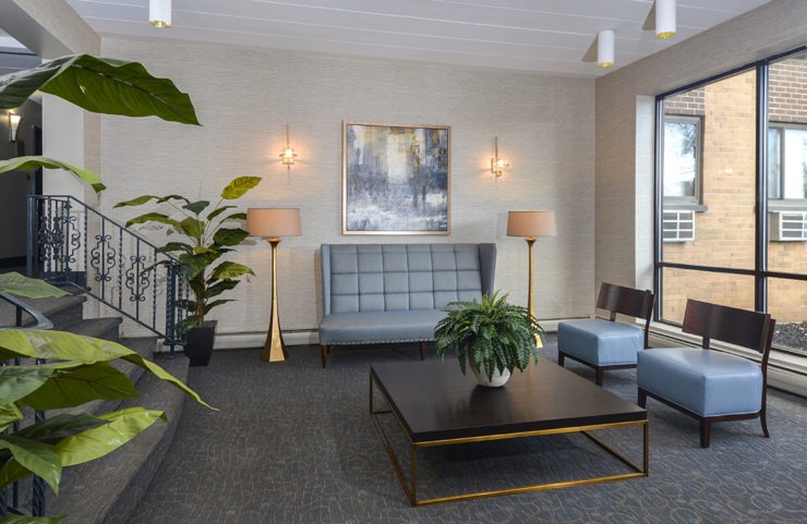 lobby with seating and large windows 