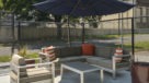 comfy seating area with blue umbrella for shade 